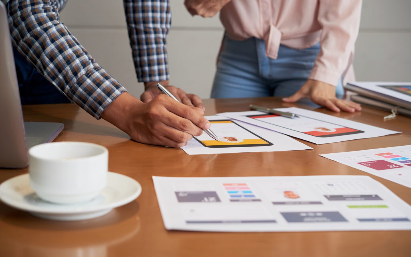 Hands of product manager making corrections on interface image